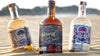 Siempre Tequila Combo with three 750 ML bottles on sandy beach.